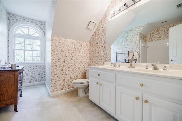 bathroom featuring walk in shower, vanity, and toilet