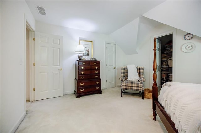 carpeted bedroom with a walk in closet, a closet, and lofted ceiling