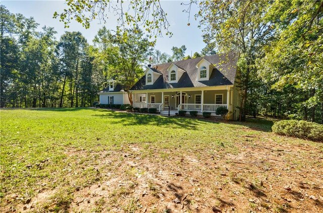 view of front facade with a front yard and a porch