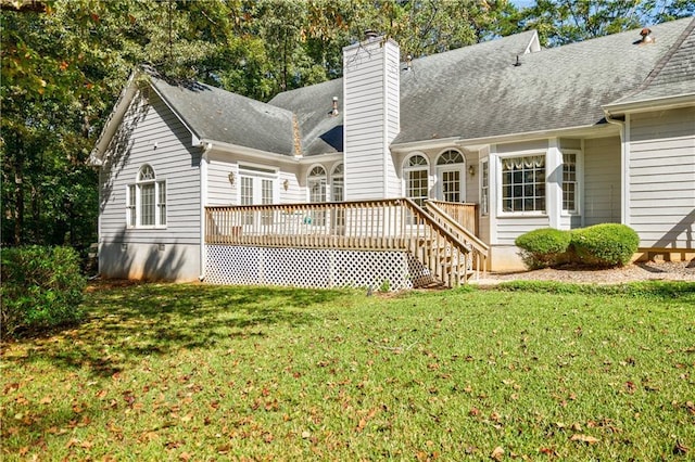 rear view of property with a lawn and a deck