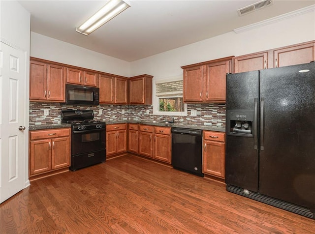 5260 Sherwood Way, Cumming, GA 30040 - kitchen featuring black appliances, dark countertops, dark wood finished floors, and backsplash