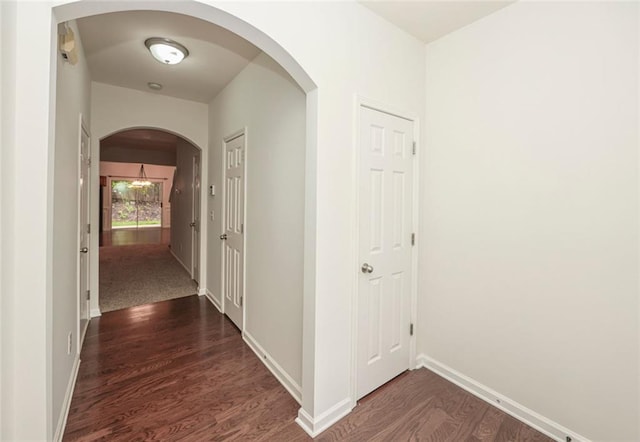 5260 Sherwood Way, Cumming, GA 30040 - corridor with arched walkways, dark wood-style floors, and baseboards