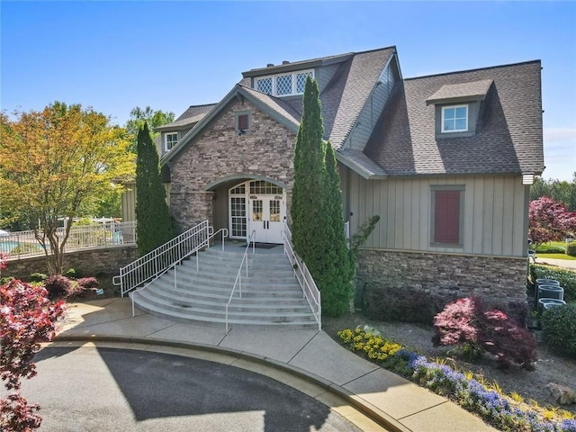 5260 Sherwood Way, Cumming, GA 30040 - view of front of home with stone siding, french doors, a shingled roof, and board and batten siding