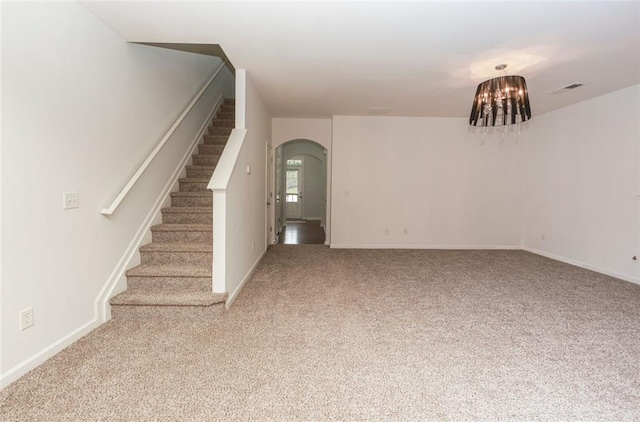 5260 Sherwood Way, Cumming, GA 30040 - unfurnished living room with arched walkways, stairway, carpet floors, and baseboards