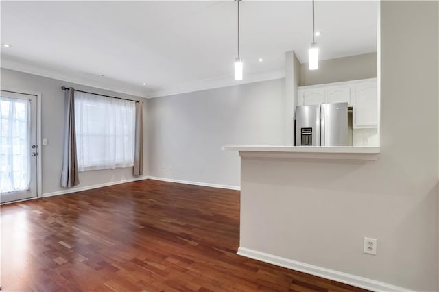 unfurnished living room featuring crown molding and dark wood-type flooring