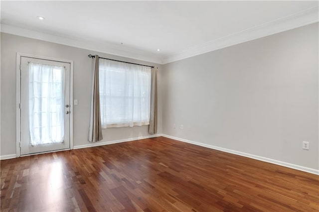 empty room with crown molding and hardwood / wood-style floors