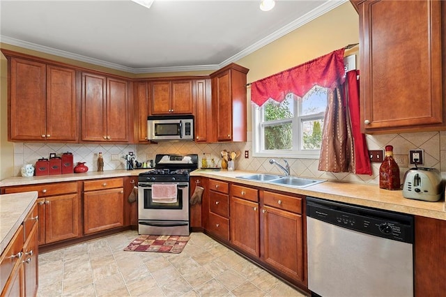 kitchen with decorative backsplash, sink, ornamental molding, and appliances with stainless steel finishes