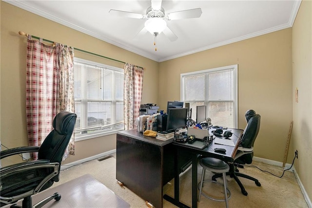 carpeted home office with plenty of natural light, ornamental molding, and ceiling fan