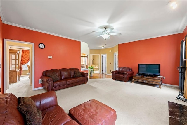 carpeted living room with crown molding and ceiling fan