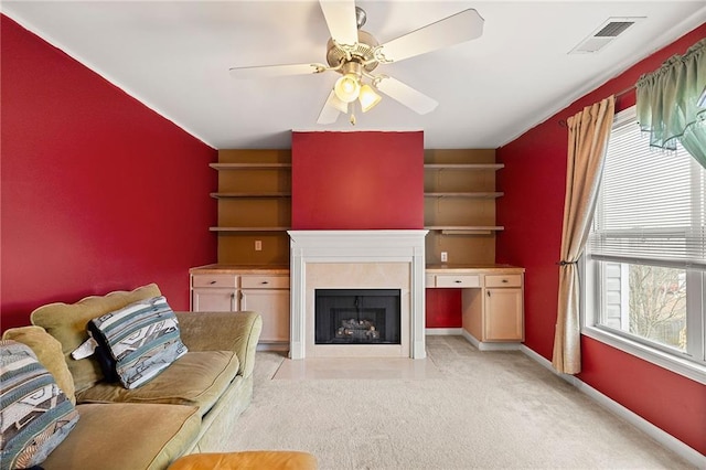 unfurnished living room featuring ceiling fan and light colored carpet