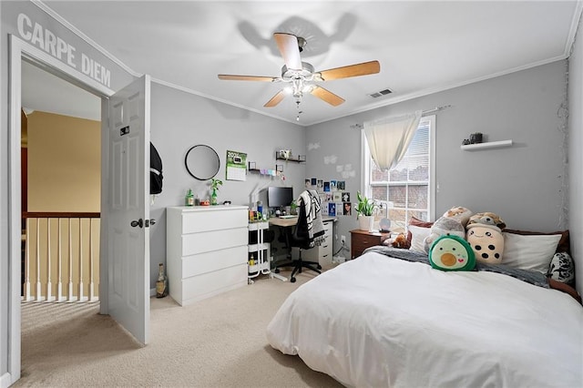 carpeted bedroom with ceiling fan and ornamental molding