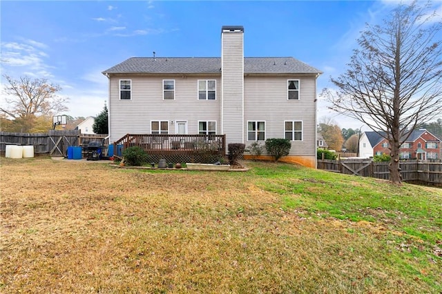 back of house with a yard and a wooden deck