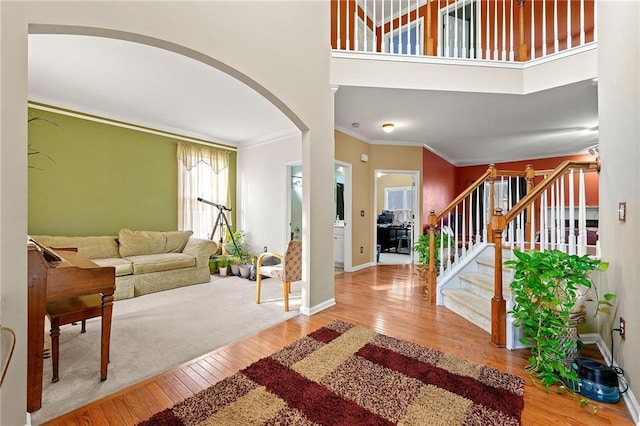 foyer entrance featuring wood-type flooring and crown molding