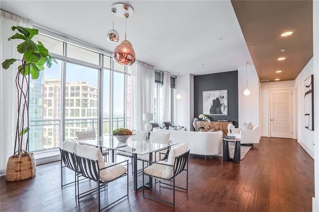 dining area with dark hardwood / wood-style flooring and floor to ceiling windows