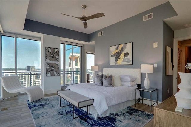 bedroom featuring ceiling fan, access to exterior, and light wood-type flooring