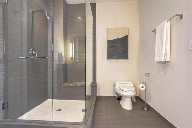 bathroom with walk in shower, tile patterned floors, and toilet