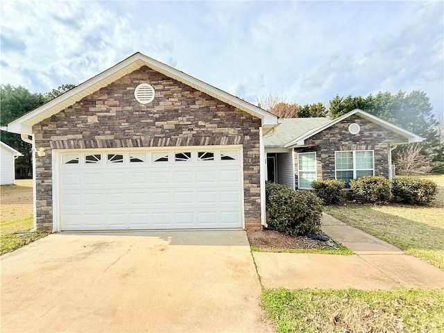 ranch-style home with a garage, concrete driveway, and stone siding