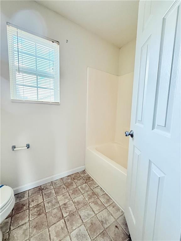 bathroom featuring toilet and baseboards