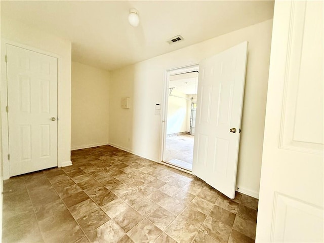 empty room featuring visible vents and baseboards