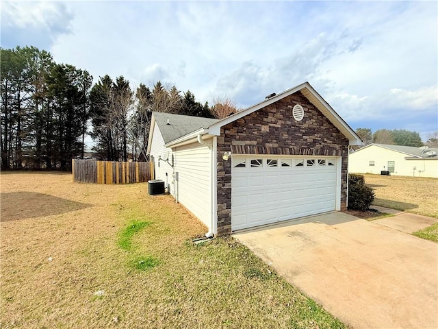 view of property exterior featuring concrete driveway, stone siding, an attached garage, fence, and central AC