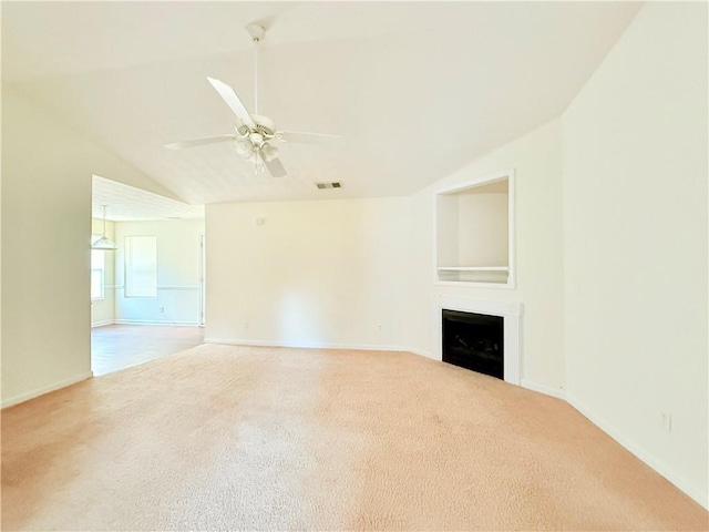 unfurnished living room featuring visible vents, a ceiling fan, carpet, vaulted ceiling, and a fireplace