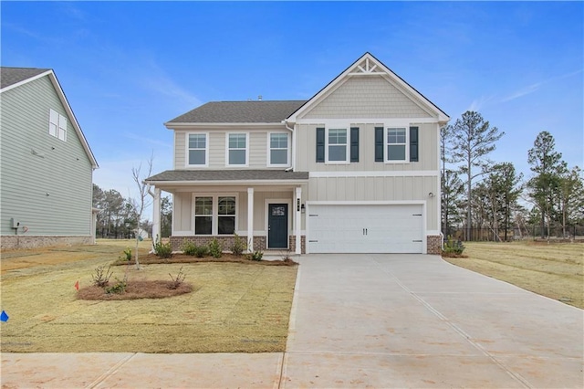 craftsman house with a front yard and a garage