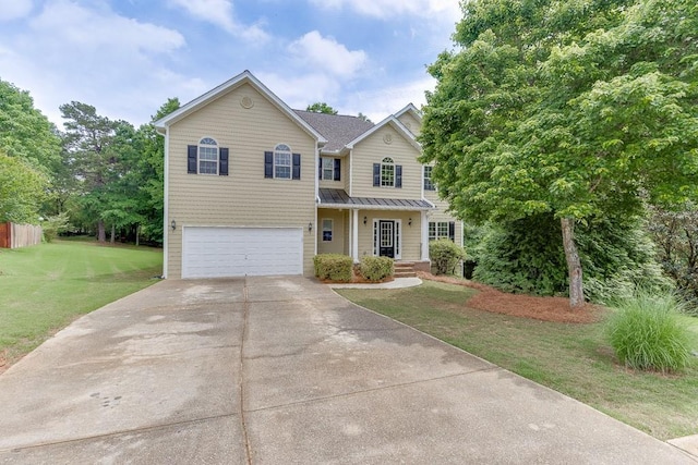 traditional home featuring a standing seam roof, driveway, metal roof, a garage, and a front lawn
