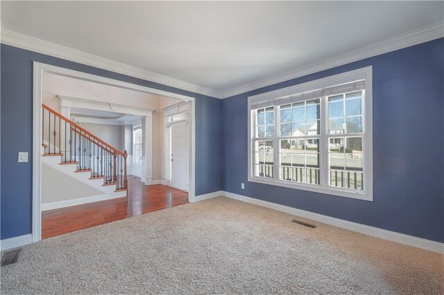 carpeted spare room with ornamental molding