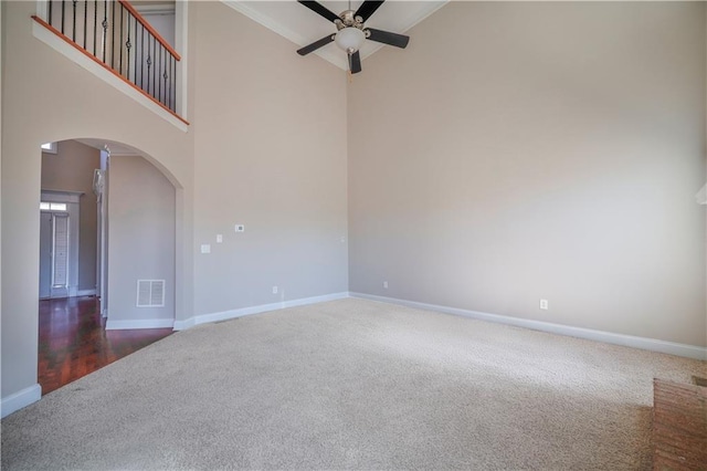 empty room featuring high vaulted ceiling, ceiling fan, and dark colored carpet