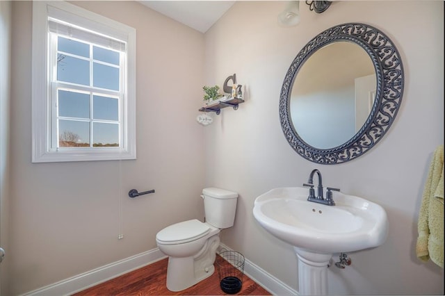 bathroom featuring hardwood / wood-style flooring, sink, and toilet