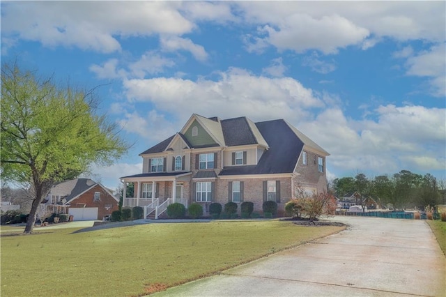 craftsman-style house with a front yard and covered porch