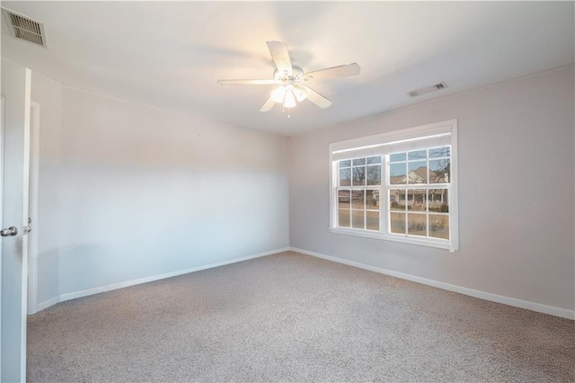 carpeted empty room featuring ceiling fan