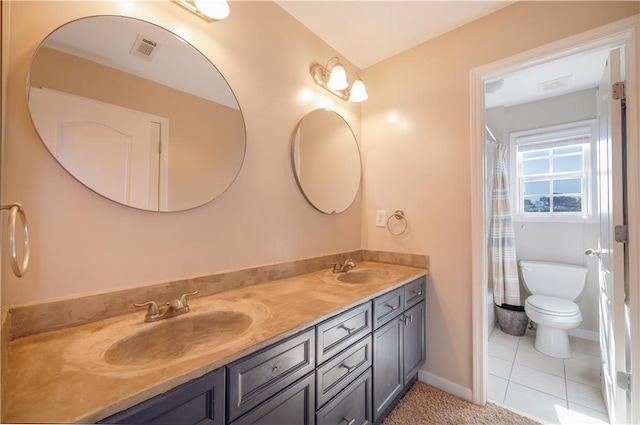 bathroom with vanity, walk in shower, tile patterned floors, and toilet