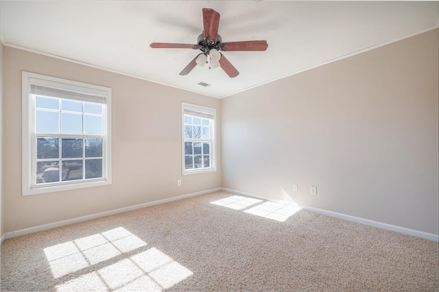 carpeted spare room featuring ornamental molding and ceiling fan