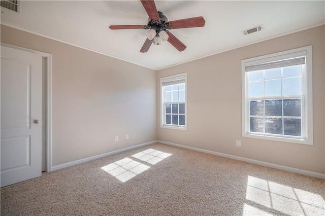 carpeted empty room with ornamental molding and ceiling fan