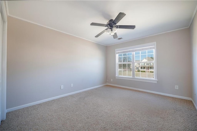 unfurnished room with crown molding, carpet floors, and ceiling fan