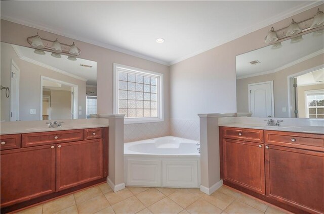 bathroom featuring a bathing tub, ornamental molding, tile patterned floors, and vanity