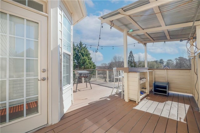 wooden deck featuring exterior bar