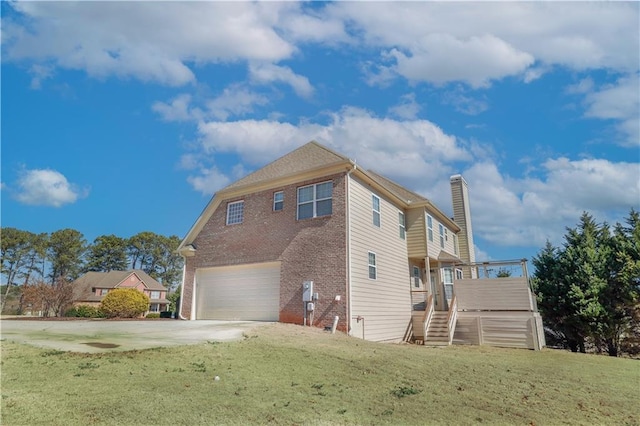 view of side of property featuring a garage and a lawn