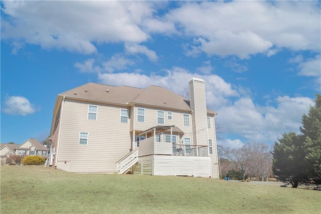 rear view of house featuring a lawn