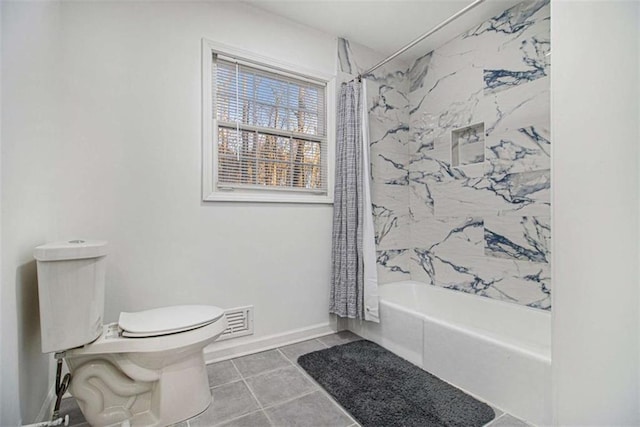 full bathroom with visible vents, toilet, shower / bath combo with shower curtain, baseboards, and tile patterned floors