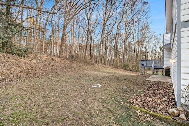 view of yard featuring a wooden deck