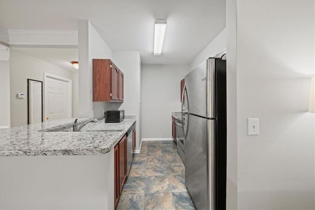 2700 Pine Tree Rd NE Unit 1214, Atlanta, GA 30324 - kitchen featuring a sink, baseboards, a peninsula, appliances with stainless steel finishes, and stone finish floor