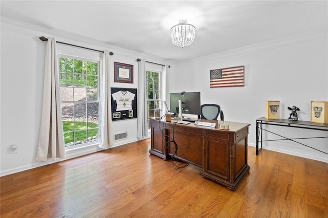 office with crown molding, a notable chandelier, light wood-style floors, baseboards, and visible vents