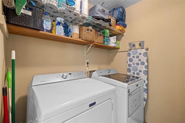 washroom featuring washing machine and clothes dryer and laundry area