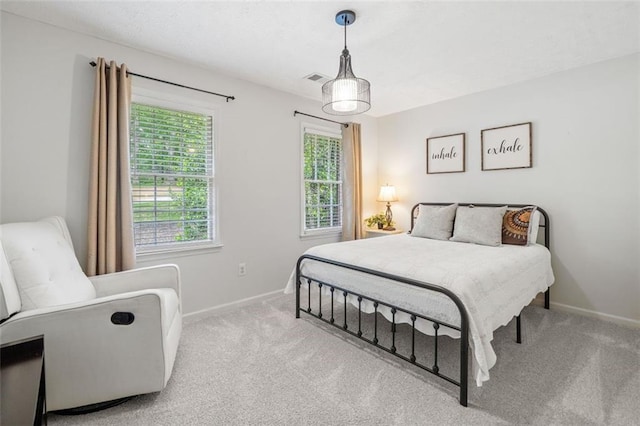 carpeted bedroom with baseboards and visible vents
