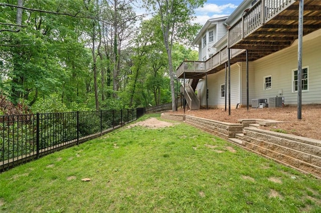view of yard featuring fence, a wooden deck, central AC unit, and stairway