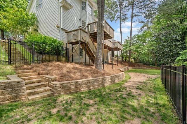 back of house with fence private yard, a wooden deck, and stairs