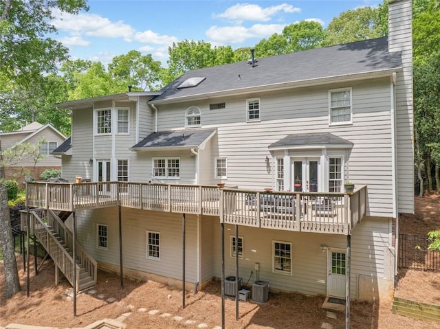 back of property with french doors, a chimney, a wooden deck, stairway, and central air condition unit