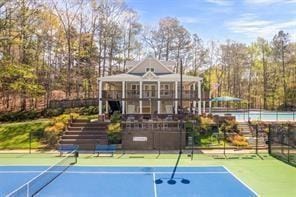 view of tennis court featuring fence